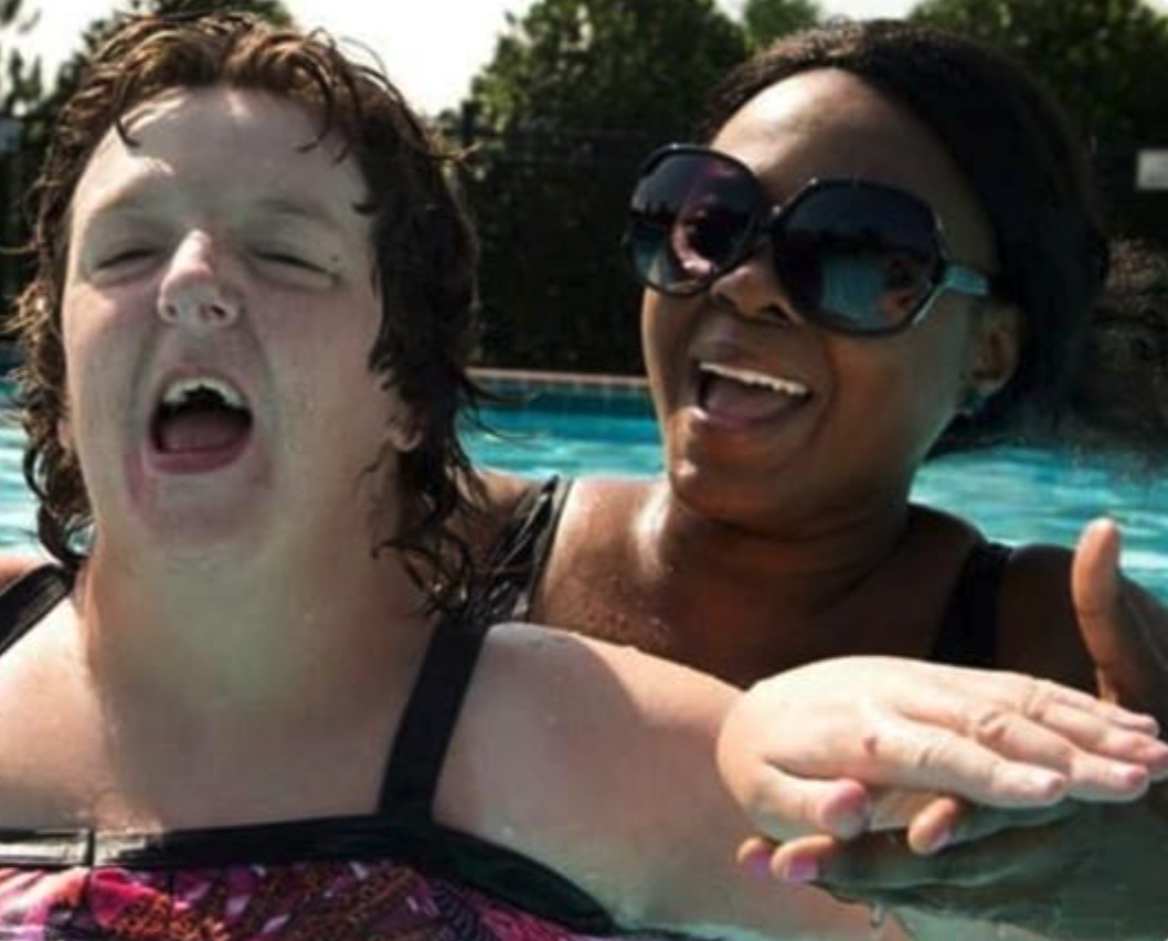 A Georgia Options DSP and an individual enjoy the pool through one of Georgia Options’ community programs.